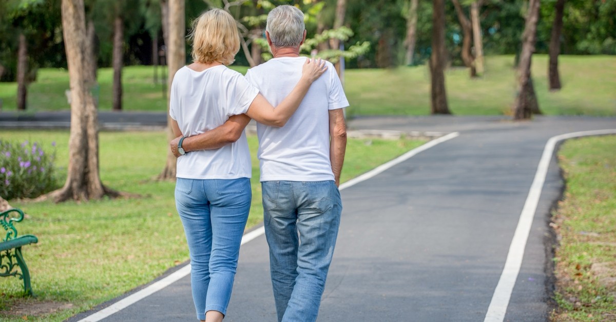 An image of a senior couple walking on a path