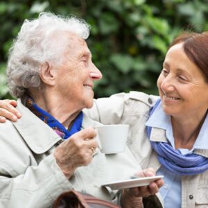 An elderly person and a mature woman